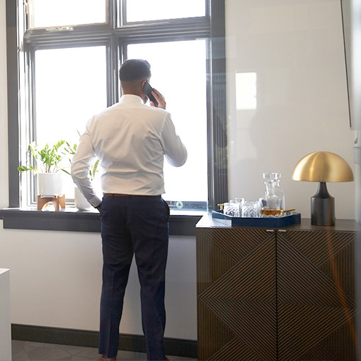 Arif making a phone call in downtown office