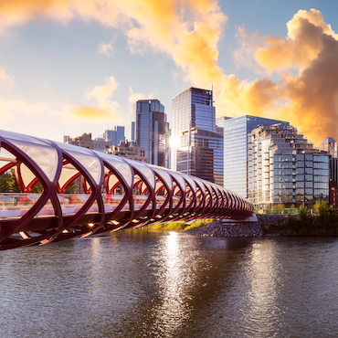 Peace Bridge across Bow River to downtown Calgary skyline